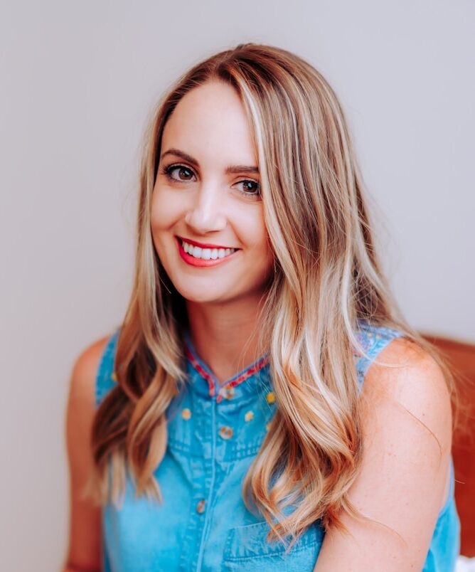 smiling girl in blue sleeveless dress