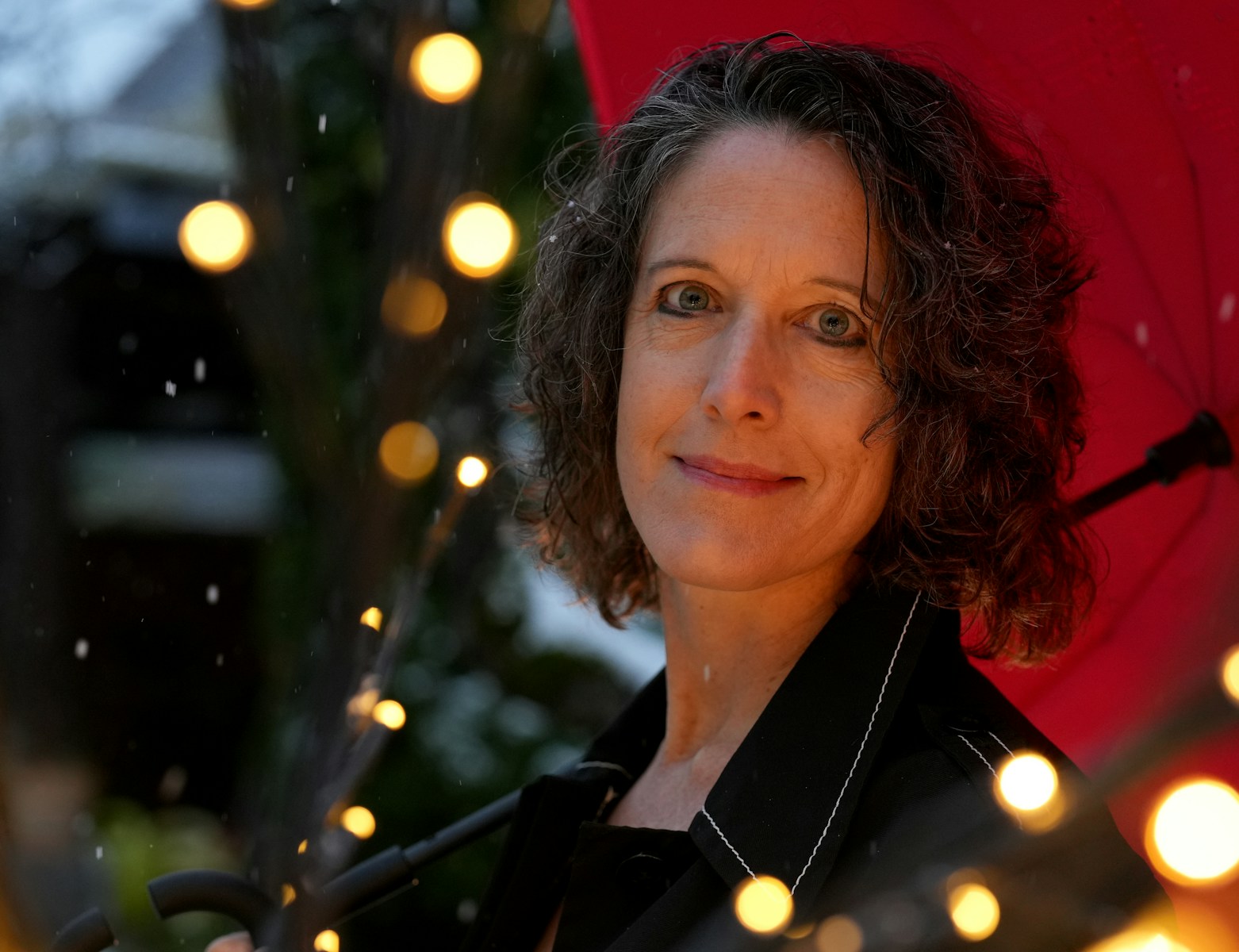 A woman holding an umbrella in the rain